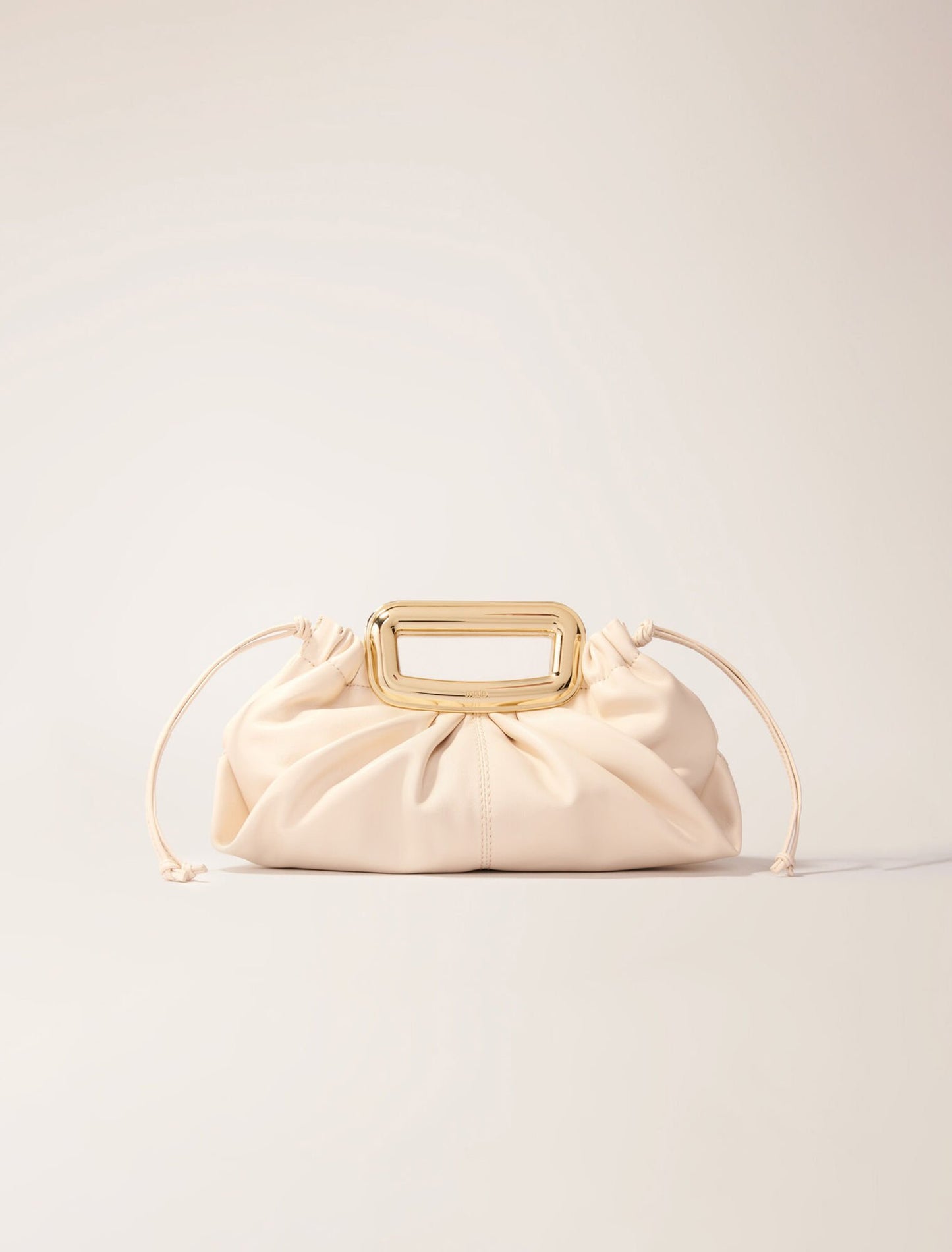 Ecru-featured-Metal handle leather clutch