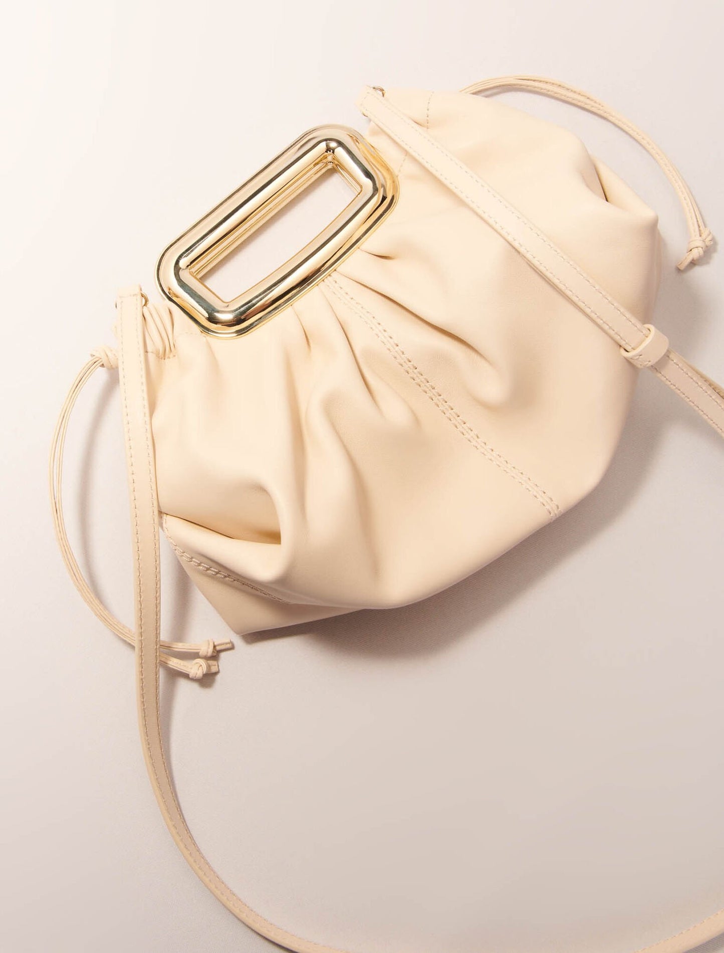 Ecru-Metal handle leather clutch