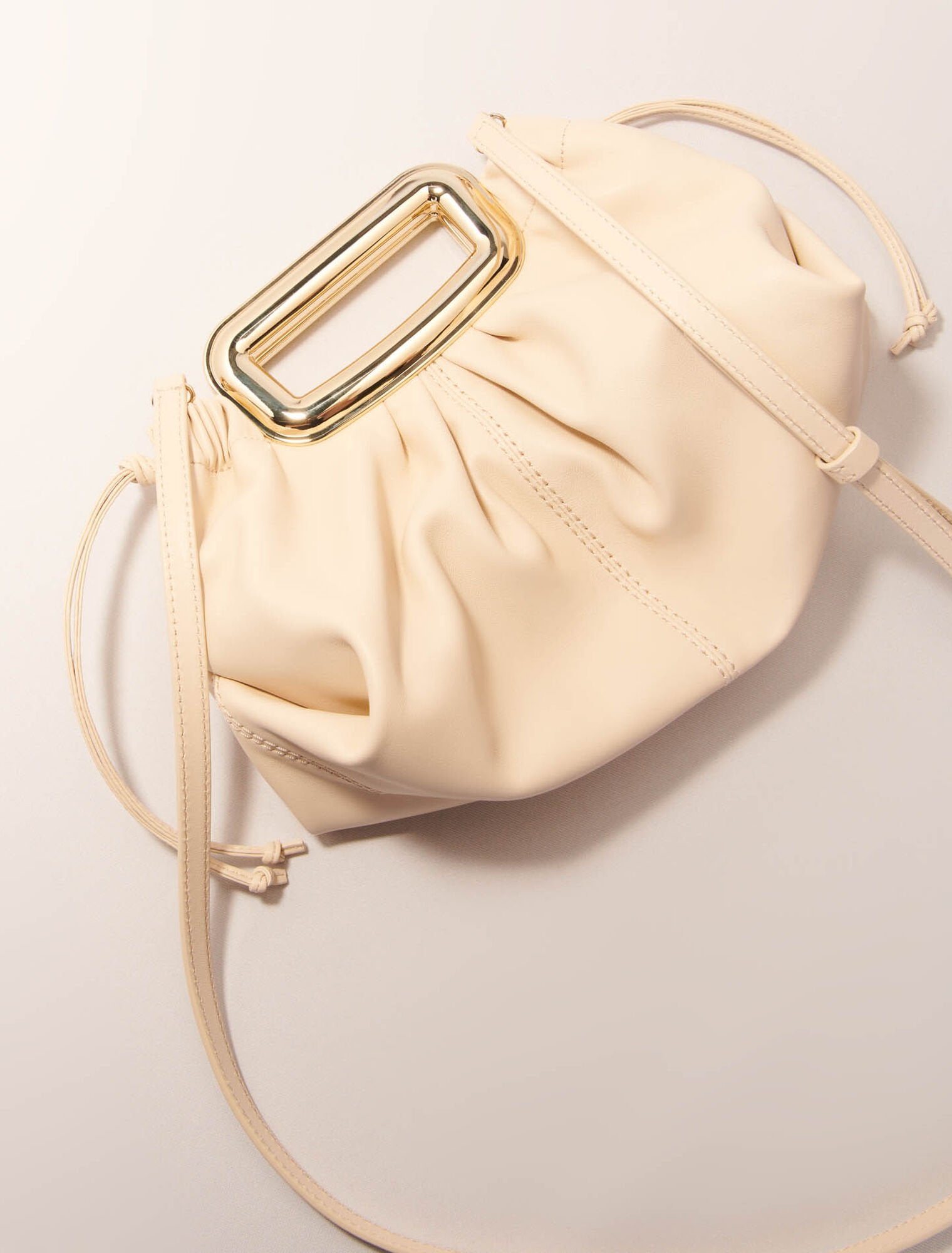 Ecru-Metal handle leather clutch
