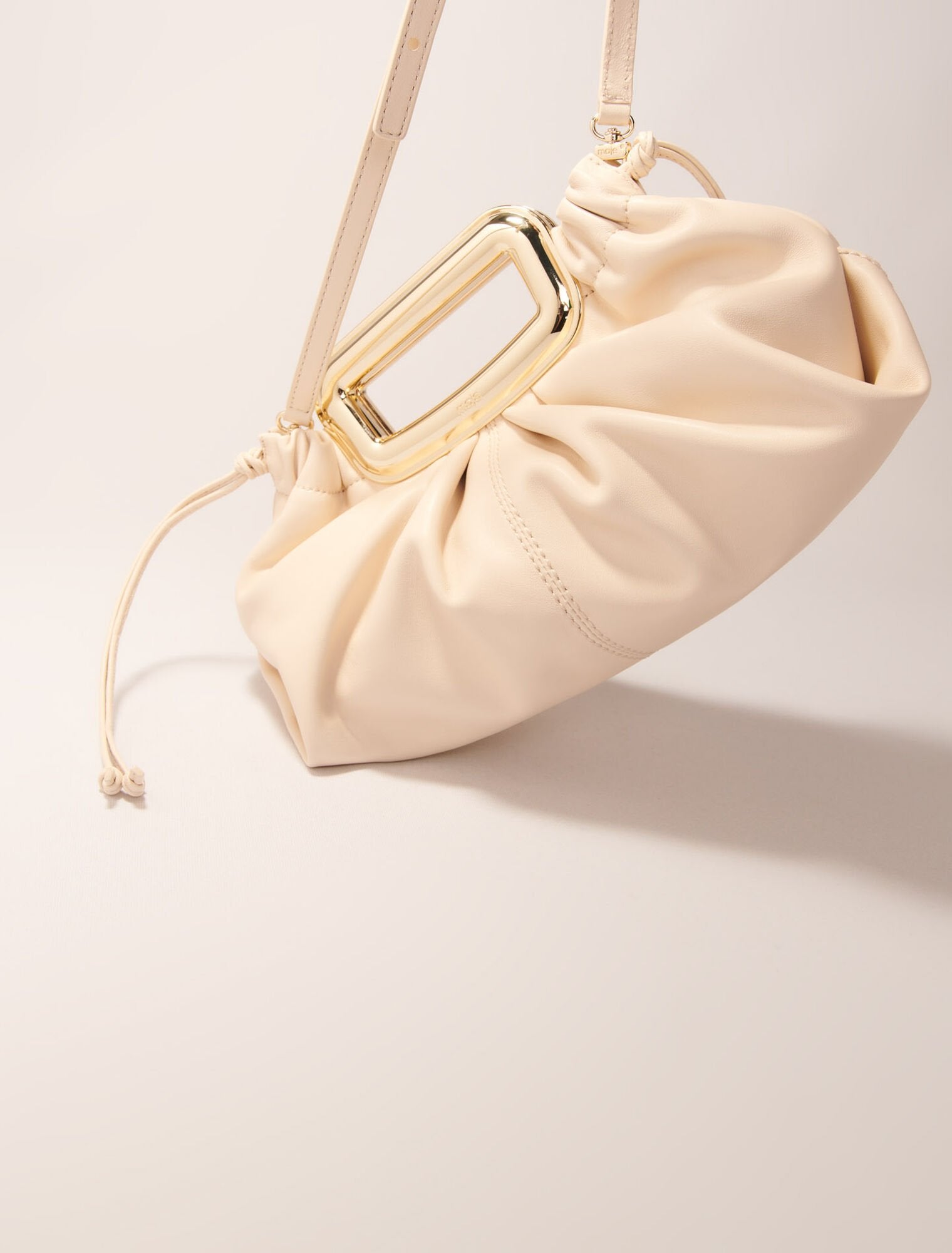 Ecru-Metal handle leather clutch