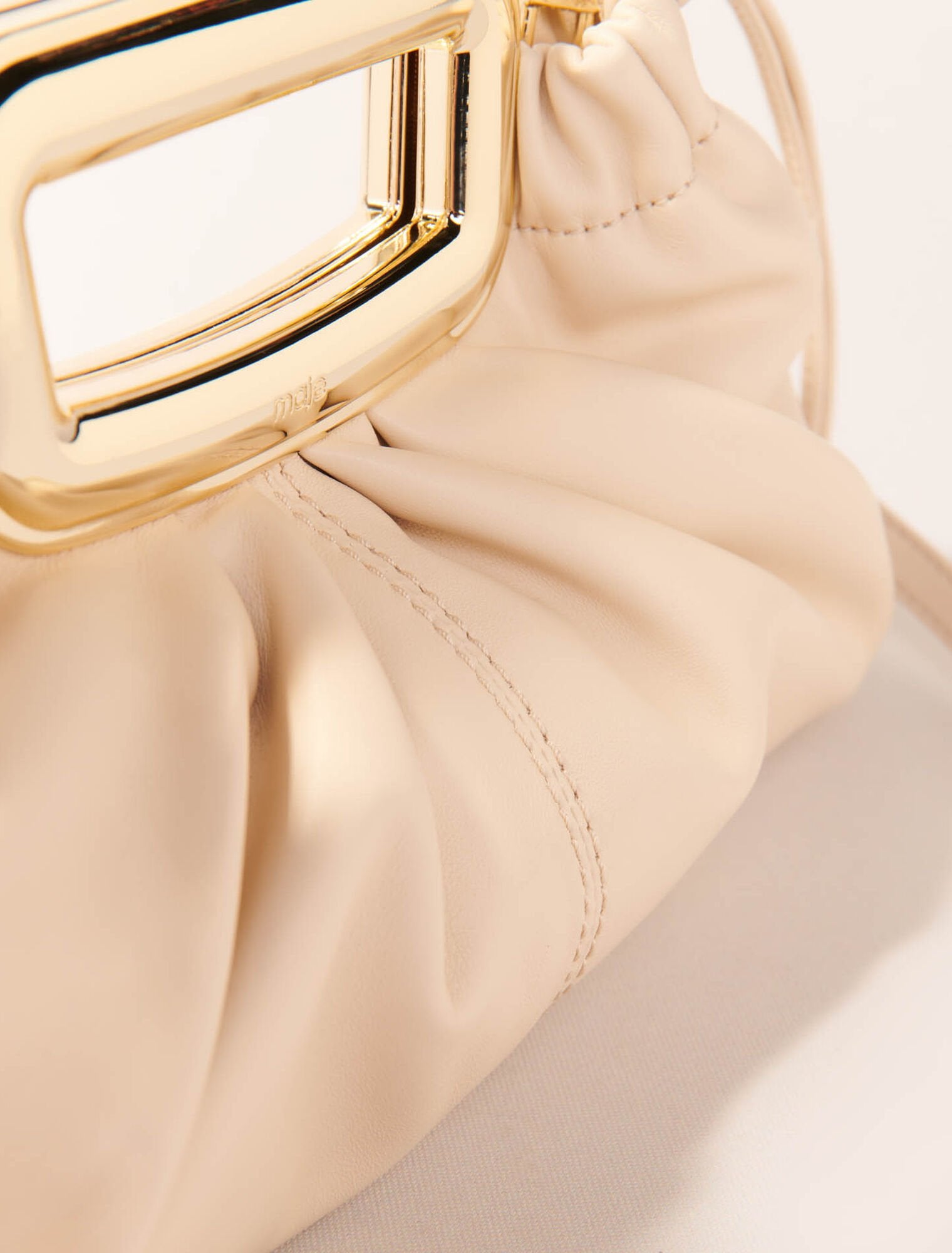 Ecru-Metal handle leather clutch