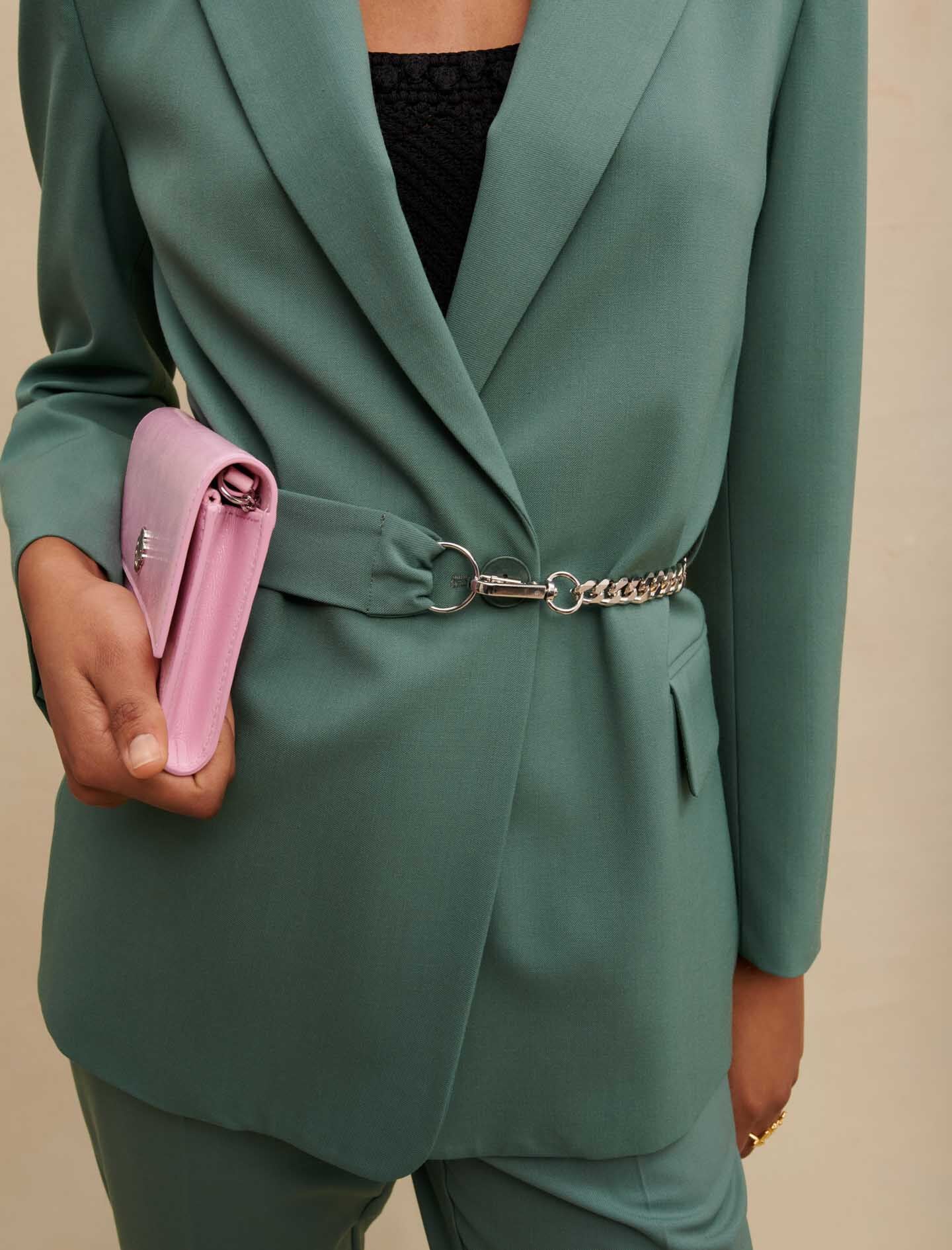 Green-tailored jacket with chain belt